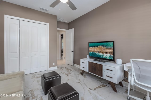 living area featuring visible vents, baseboards, marble finish floor, and a ceiling fan