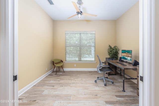 office space featuring ceiling fan, visible vents, baseboards, and wood finished floors