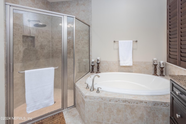 bathroom featuring vanity, a garden tub, a stall shower, and tile patterned flooring