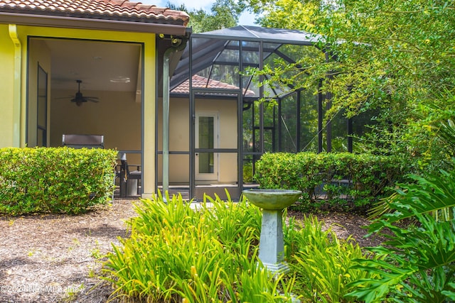 doorway to property featuring a tile roof and stucco siding