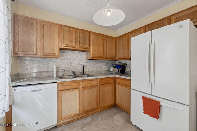 kitchen featuring white appliances, a sink, light countertops, a textured ceiling, and backsplash