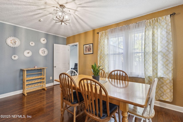 dining space featuring an inviting chandelier, wood finished floors, and baseboards