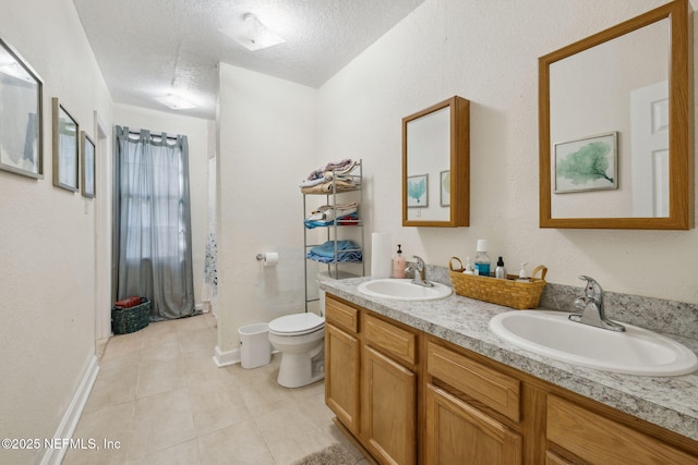 bathroom featuring a sink, a textured ceiling, tile patterned flooring, and toilet