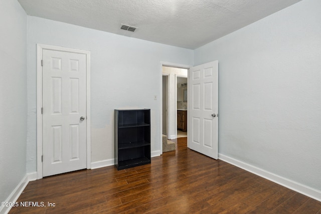 unfurnished bedroom with dark wood-style floors and baseboards