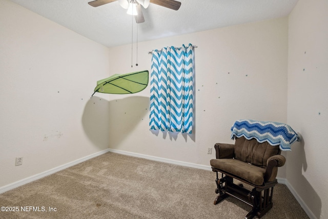 living area featuring baseboards, carpet floors, and ceiling fan