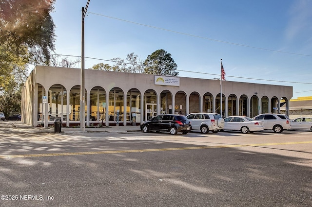 view of building exterior with uncovered parking