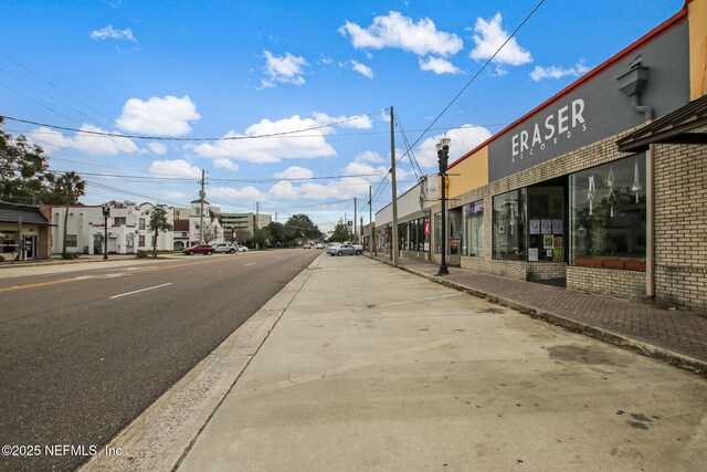 view of street with sidewalks and curbs