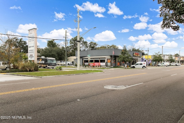 view of street with curbs, street lighting, and sidewalks