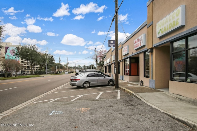 view of street featuring curbs, street lighting, and sidewalks