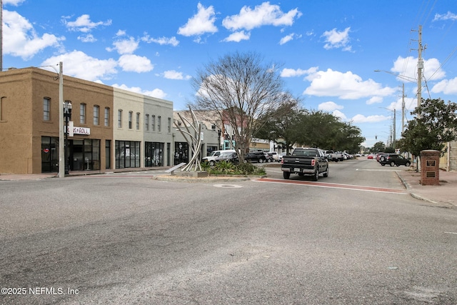 view of road with curbs, street lights, and sidewalks