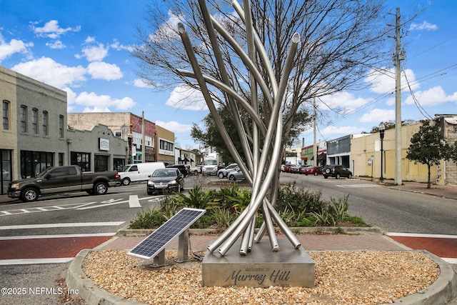 view of street featuring curbs, street lights, and sidewalks