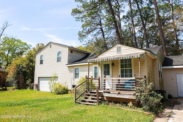 view of front of home featuring a front yard, driveway, an attached garage, covered porch, and a shingled roof