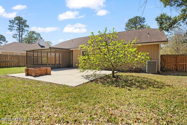 rear view of property with a lawn, a fenced backyard, cooling unit, a sunroom, and a patio area