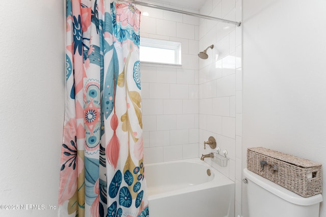 bathroom featuring toilet and shower / tub combo