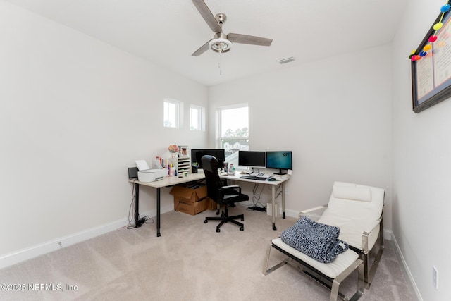 office with visible vents, baseboards, ceiling fan, and carpet flooring