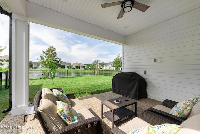 view of patio / terrace with area for grilling, a fenced backyard, ceiling fan, outdoor lounge area, and a residential view