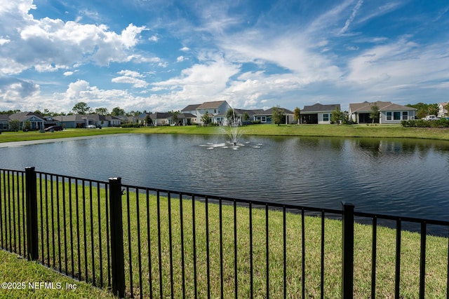 water view featuring a residential view and fence