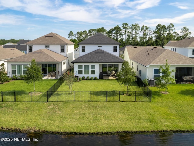 back of house featuring a patio, a fenced backyard, a residential view, and central AC