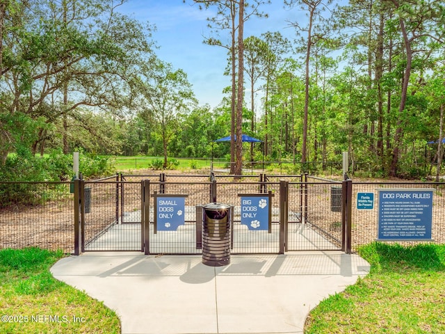 view of property's community with a gate and fence