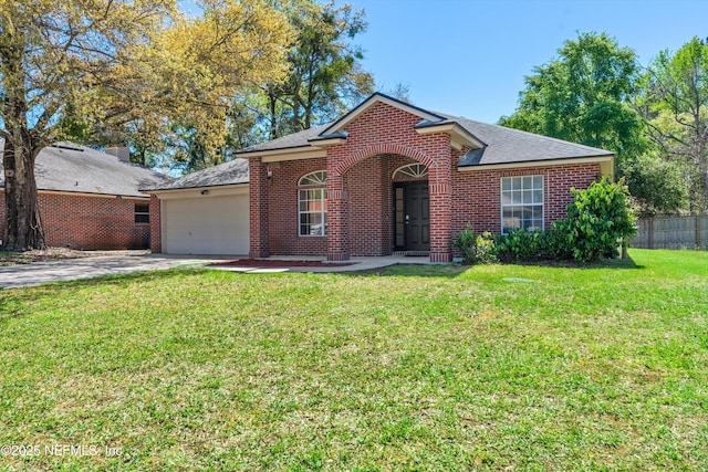 ranch-style house with a front yard, fence, driveway, a garage, and brick siding