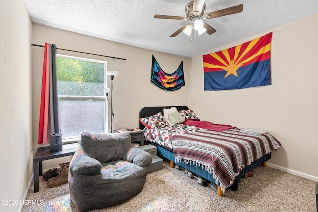 bedroom with a ceiling fan, baseboards, a textured ceiling, and carpet flooring