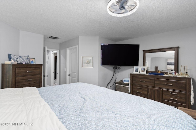 bedroom featuring visible vents and a textured ceiling