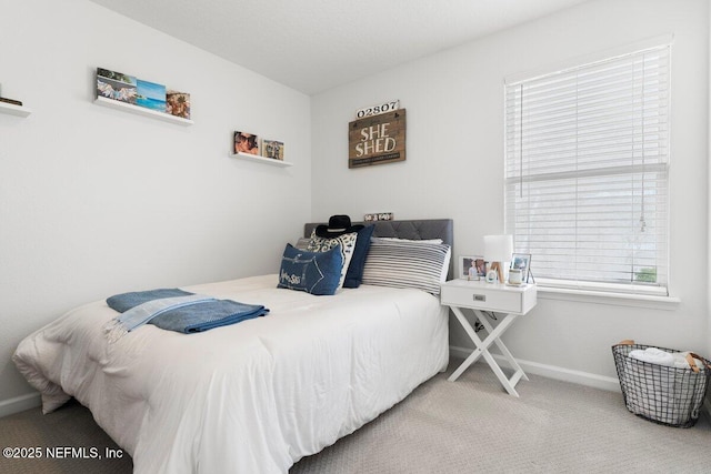 carpeted bedroom with baseboards