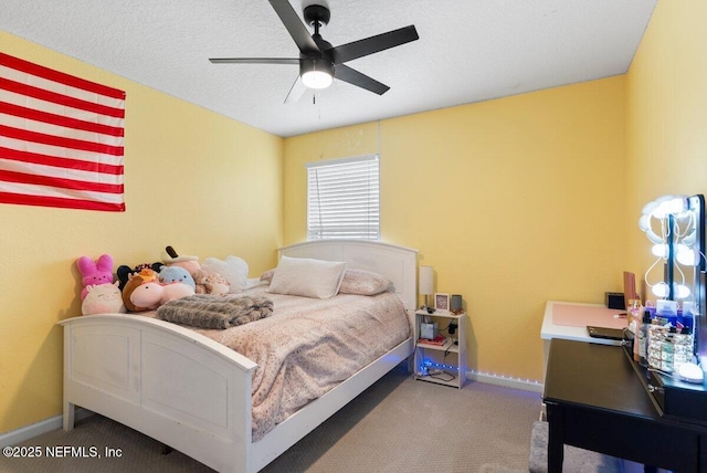 carpeted bedroom with baseboards and a textured ceiling