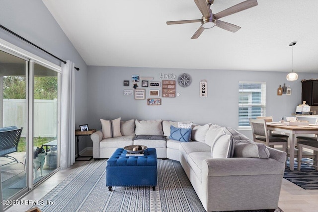 living area featuring a healthy amount of sunlight, light wood-style floors, and ceiling fan