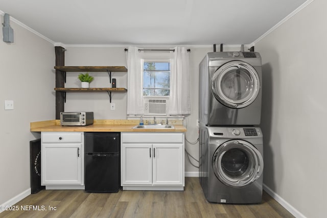 laundry room with crown molding, stacked washer / dryer, wood finished floors, and a sink