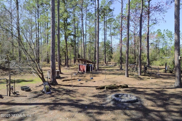 view of yard with a fire pit