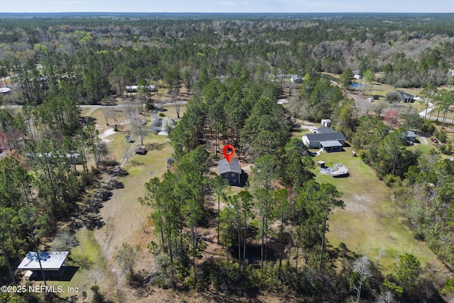 aerial view featuring a wooded view