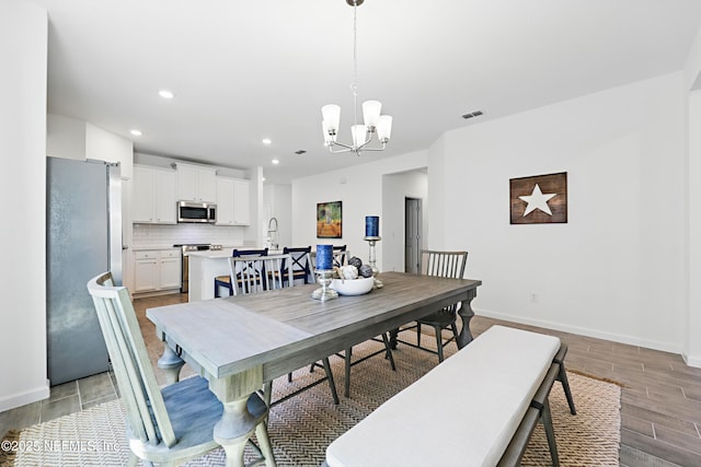 2965 Crossfield Dr, Green Cove Springs, FL 32043 - dining area with baseboards, light wood-type flooring, an inviting chandelier, recessed lighting, and visible vents