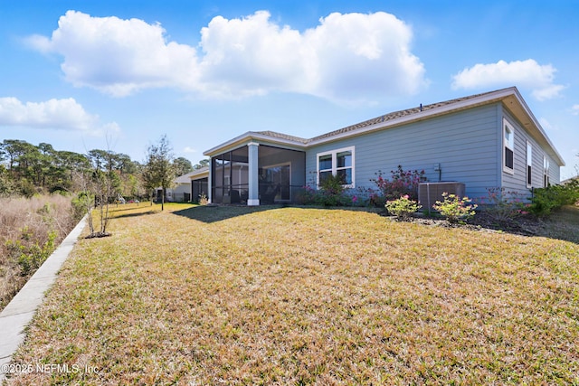 2965 Crossfield Dr, Green Cove Springs, FL 32043 - rear view of house with central air condition unit, a lawn, and a sunroom