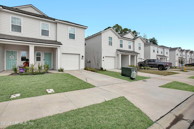 townhome / multi-family property featuring a residential view, an attached garage, concrete driveway, and a front lawn