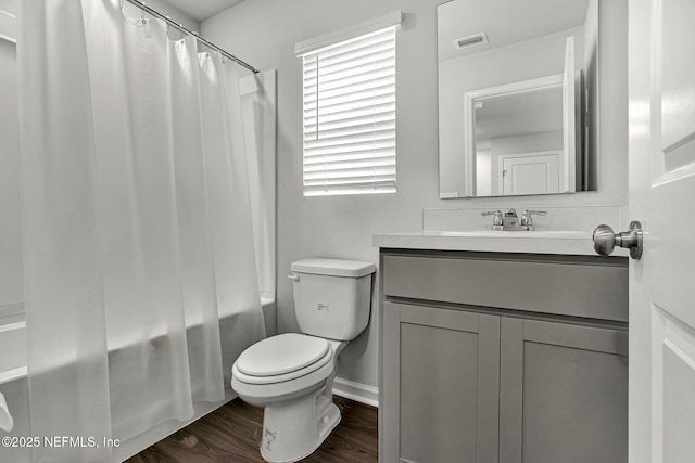 bathroom featuring visible vents, shower / tub combo with curtain, toilet, wood finished floors, and vanity