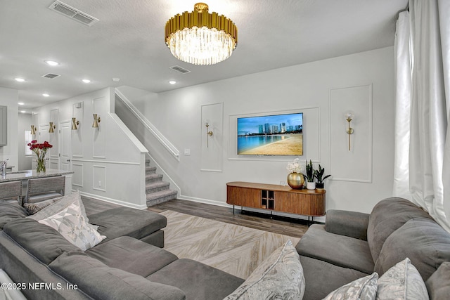 living area with stairway, recessed lighting, and visible vents