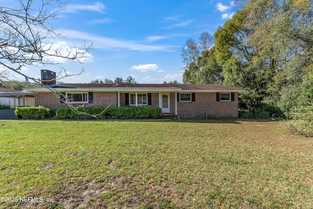 ranch-style home featuring brick siding, a front lawn, and a carport