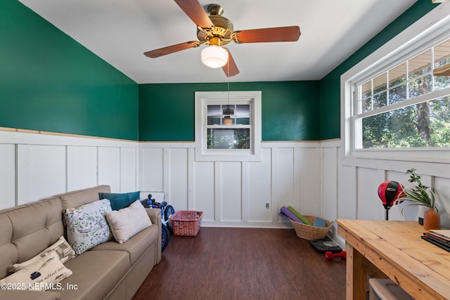 living room with ceiling fan, wood finished floors, and wainscoting