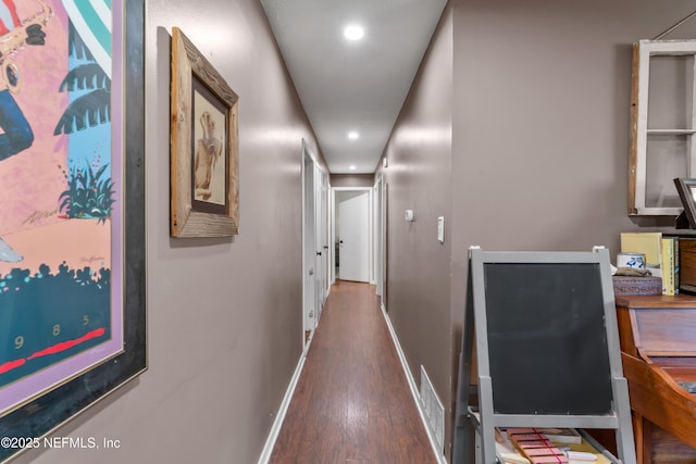 hallway with recessed lighting, wood finished floors, visible vents, and baseboards