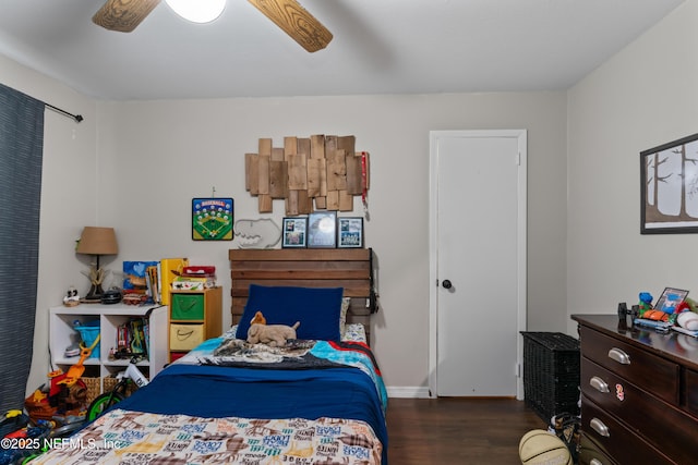 bedroom featuring a ceiling fan, wood finished floors, and baseboards