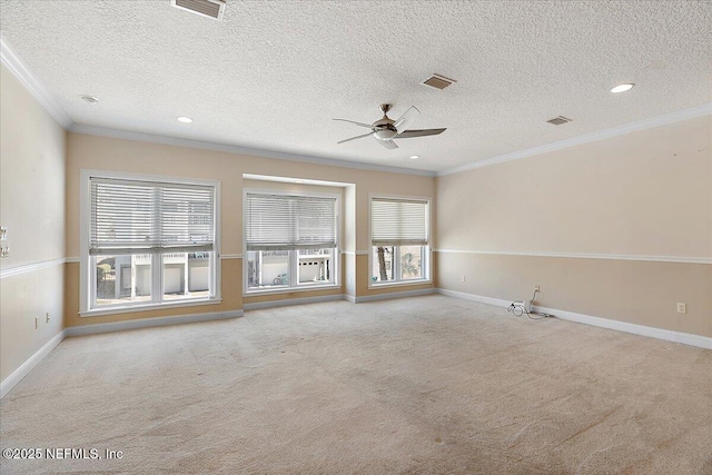 carpeted empty room with crown molding, a ceiling fan, and visible vents