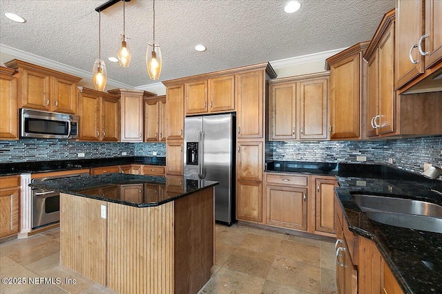 kitchen with decorative light fixtures, stainless steel appliances, brown cabinets, and a center island