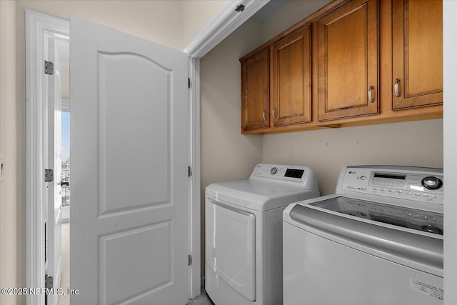 laundry area featuring cabinet space and washer and clothes dryer