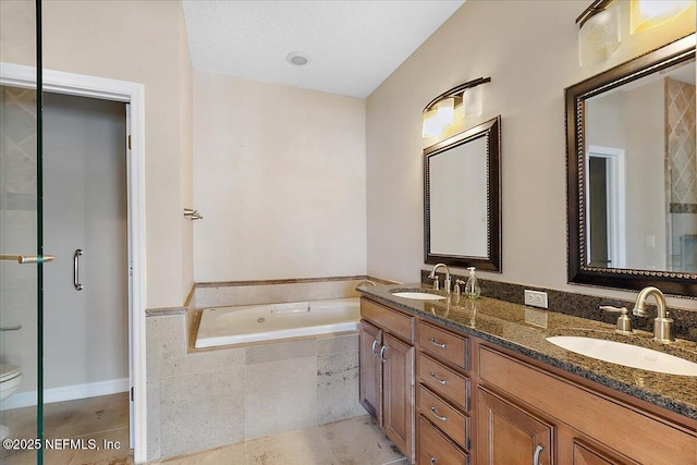 full bath with a sink, a bath, double vanity, and tile patterned floors