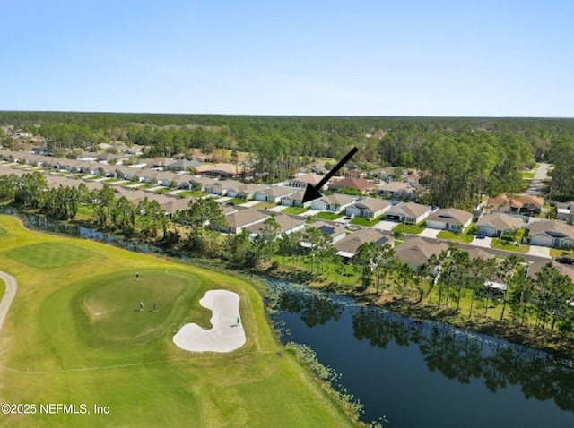 drone / aerial view featuring view of golf course, a water view, and a residential view