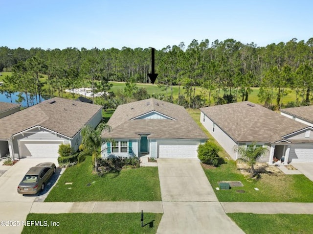 view of front of house featuring concrete driveway, a garage, and a front lawn