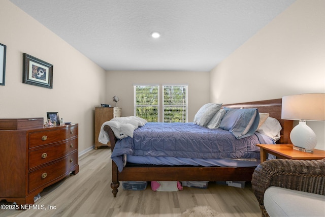 bedroom with baseboards and light wood-type flooring