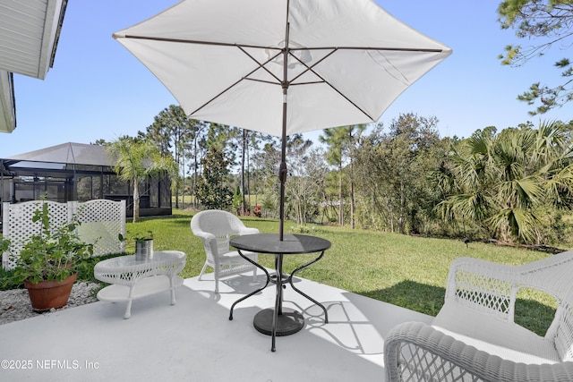 view of patio featuring glass enclosure