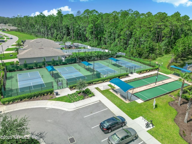 bird's eye view with a wooded view